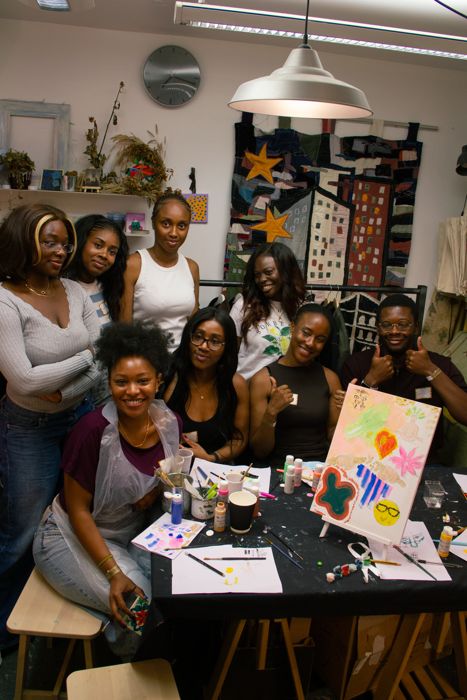 Friends with their colourful canvases